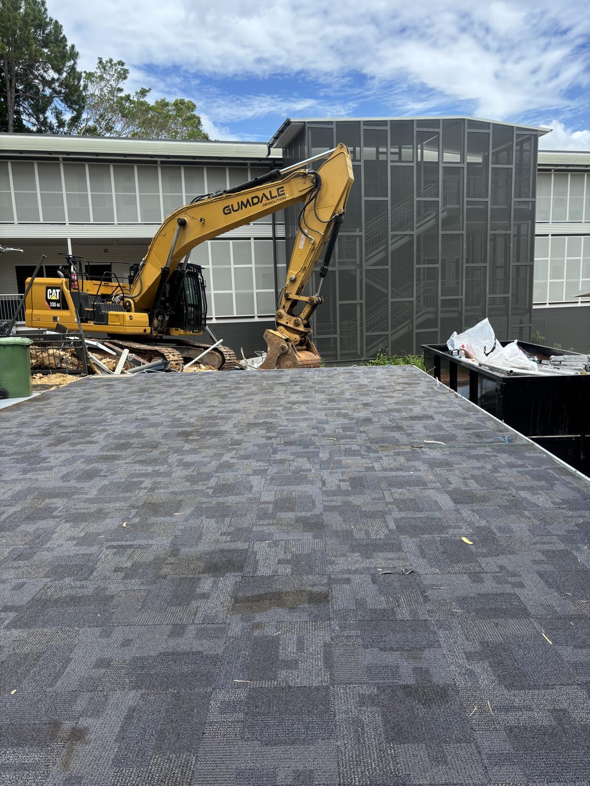 Remote Asbestos Removal at Russell Island State School 5 Russell Island State School buildings after asbestos panel removal, with the demolition contractor's excavator on site